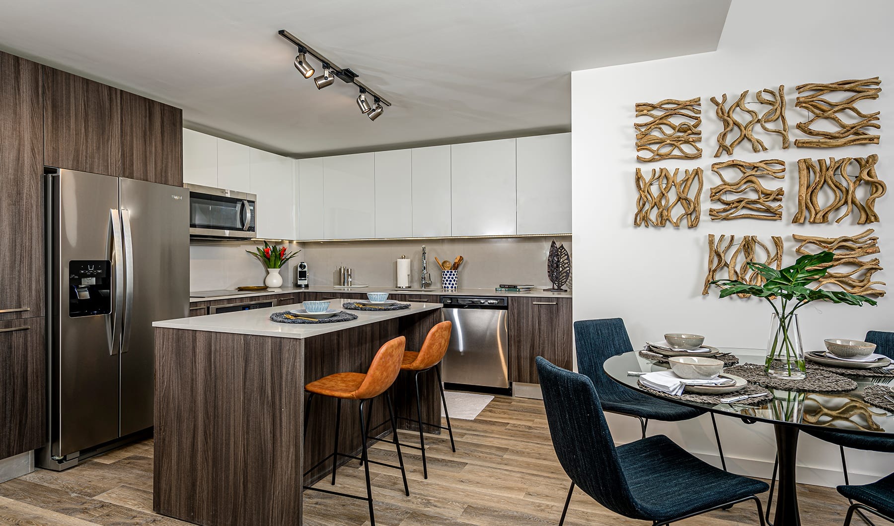 Style Everywhere You Look connected kitchen and dining areas with ample counter-space, a built-in bar table and on wood-style flooring